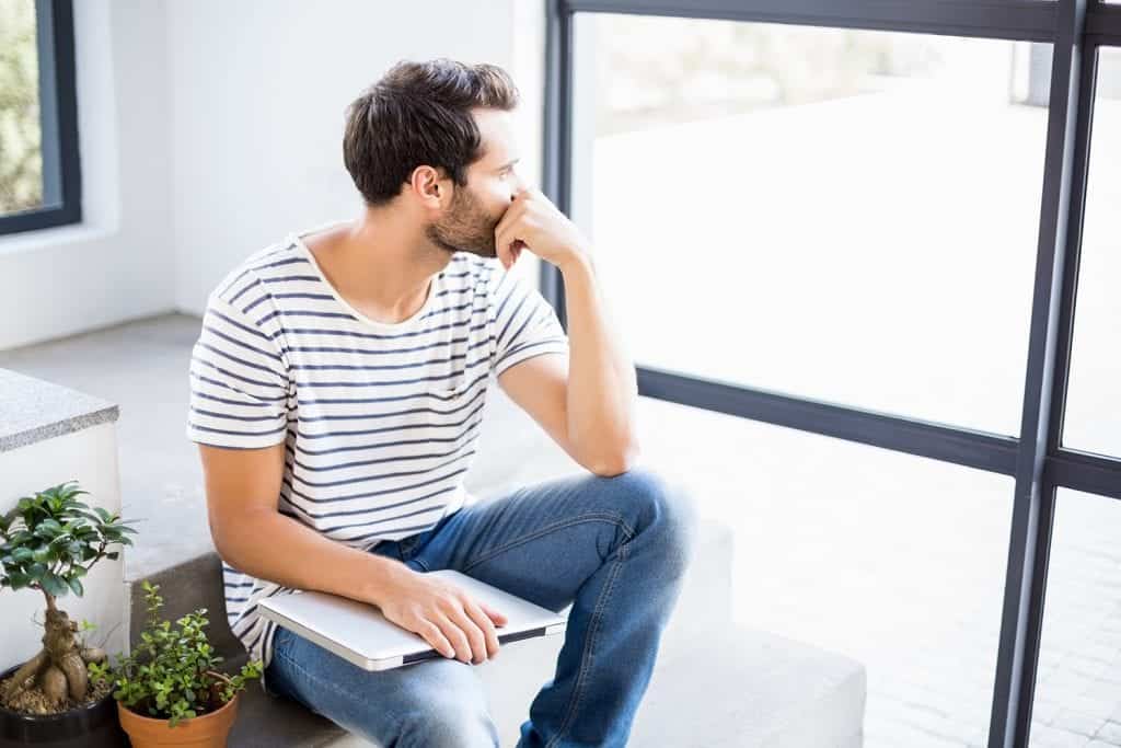 Young man looking off into the distance suicide recovery
