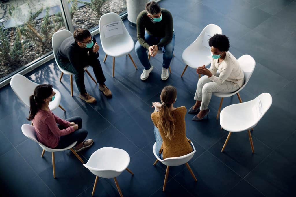 People sitting in a circle in therapy