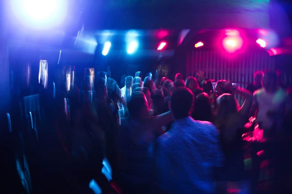 Interior of a club with people dancing binge drinking
