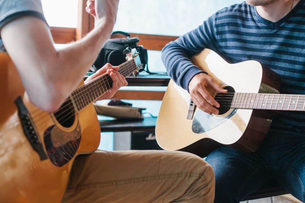Two men playin guitar