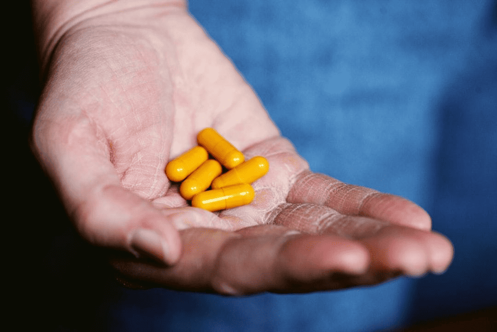 Man with pills in hand Medication Assisted Treatment