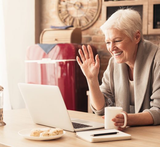 Older woman communicating via laptop video
