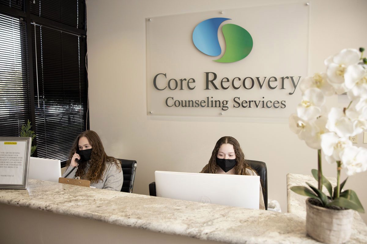 Interior of Core Recovery with woman answering phones Mental Health Treatment Centers